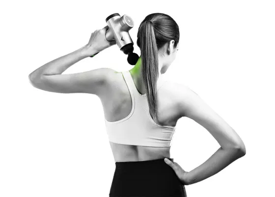 Sporty woman using a massage gun to treat pain in her neck